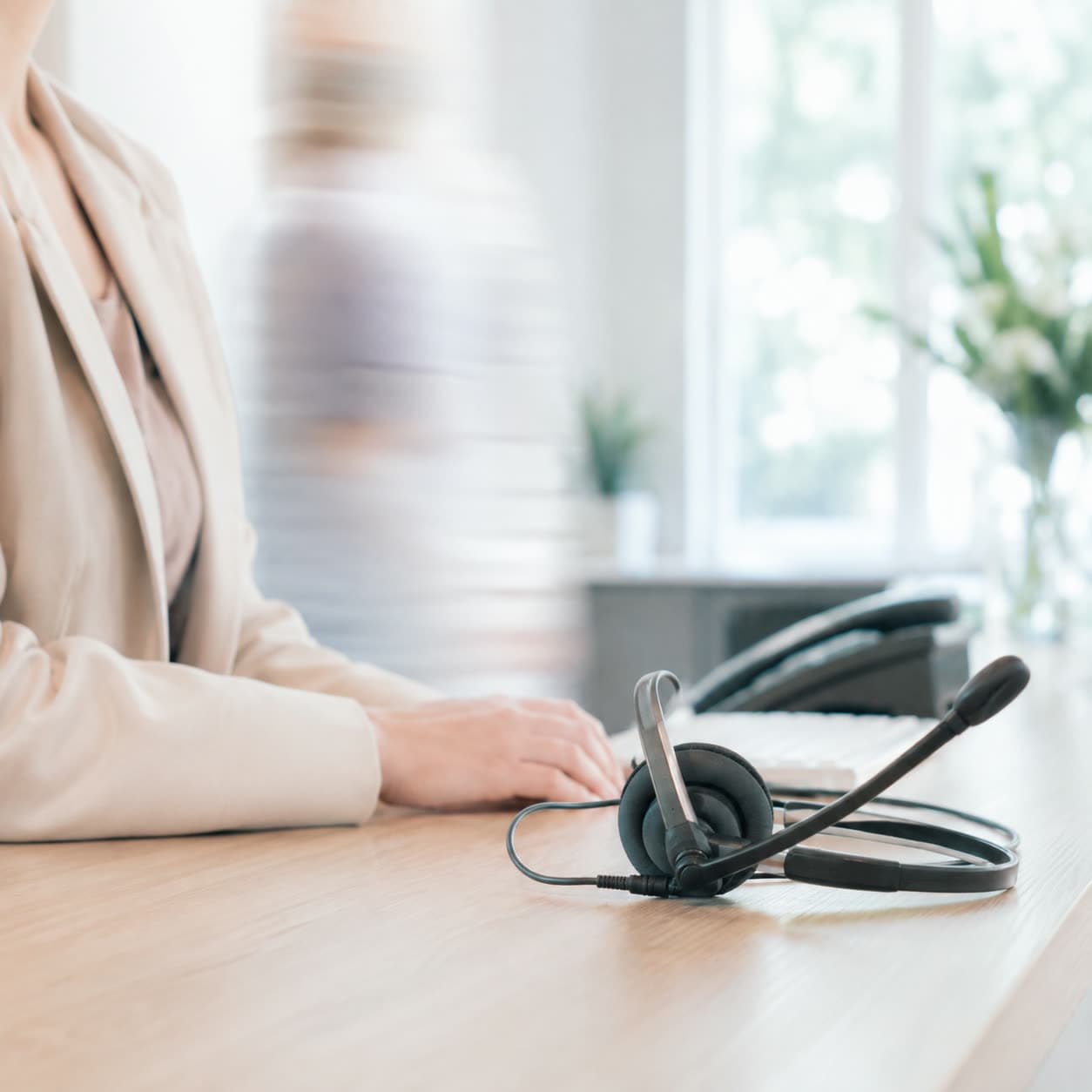 A practice front desk, headset and keyboard in close focus.